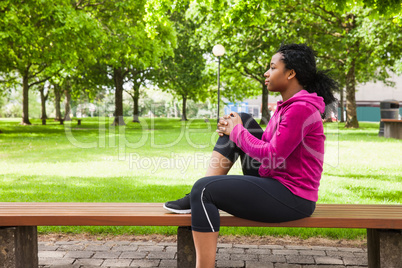 Fit woman sitting on bench