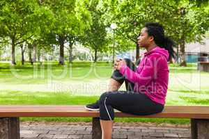 Fit woman sitting on bench