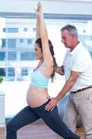 Instructor giving training to pregnant woman