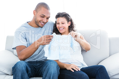 Couple looking at baby clothing