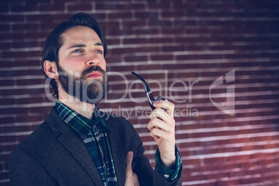 Thoughtful man smoking pipe