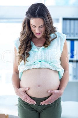 Pregnant woman touching belly