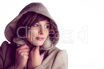 Attractive woman wearing a warm coat with hood raised