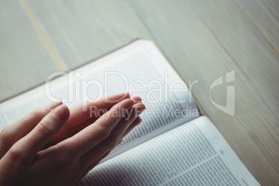 Woman praying with her bible