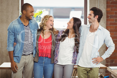 Business people standing and laughing in office