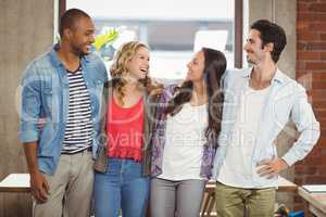 Business people standing and laughing in office