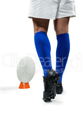 Low section of rugby player going to kick the ball