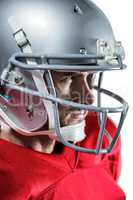 Serious American football player in red jersey looking away