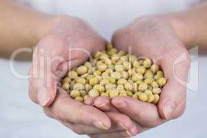 Woman showing handful of chickpeas