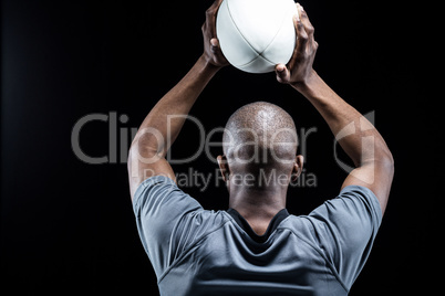 Sportsman throwing rugby ball