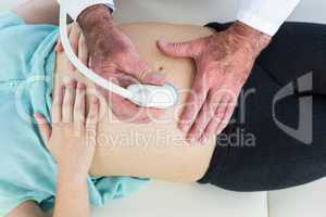 Overhead view of doctor performing ultrasound on woman