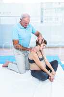 Male therapist massaging pregnant woman