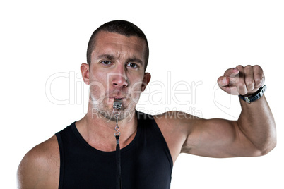 Portrait of attentive trainer blowing his whistle