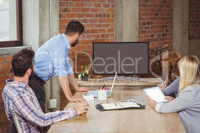 Business people looking towards screen