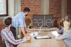 Business people looking towards screen