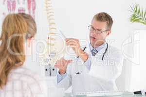 Doctor showing his patient a spine model
