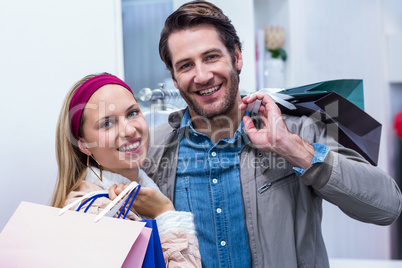 Smiling couple with shopping bags