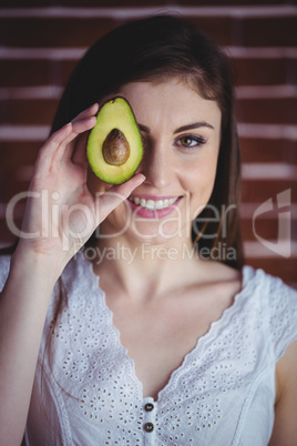 Woman showing fresh avocado