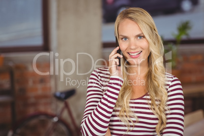 Portrait of happy businesswoman talking over phone