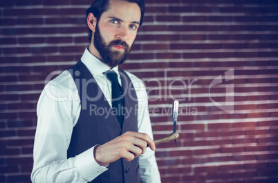 Portrait of serious man holding razor