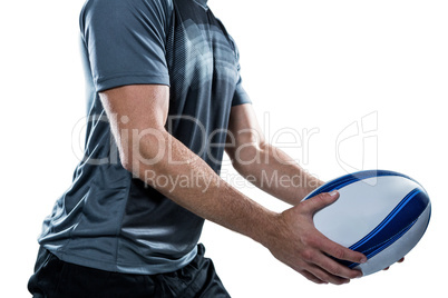Midsection of rugby player in black jersey holding ball