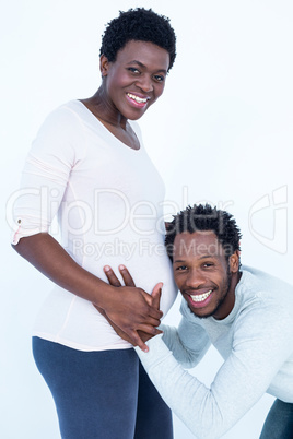 Portrait of happy smiling husband listening to his pregnant wife