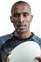 Close-up of thoughtful athlete holding rugby ball