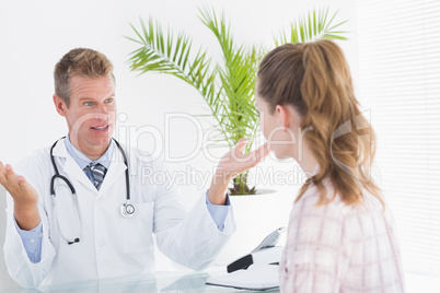 Happy doctor talking to patient