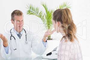Happy doctor talking to patient