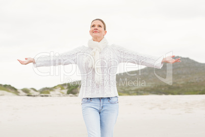 Woman standing with arms open wide