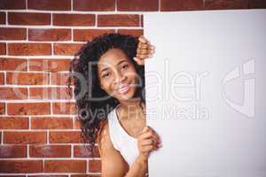 Smiling woman holding white board