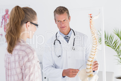 Doctor explaining the spine to his patient