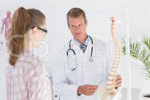 Doctor explaining the spine to his patient