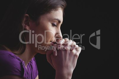 Woman praying with hands together