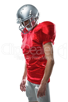 American football player in red jersey looking down