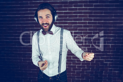 Happy hipster enjoying listening music