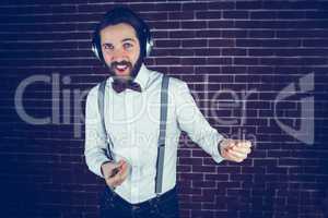 Happy hipster enjoying listening music