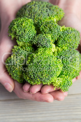 Woman showing fresh green brocolli