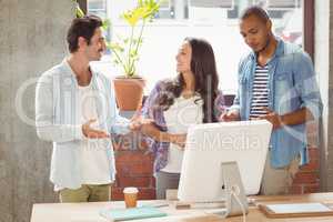Business people discussing while standing in office