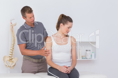 Doctor stretching woman arm