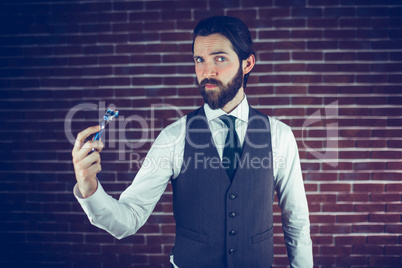 Portrait of man holding razor