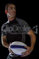Sober rugby player holding ball