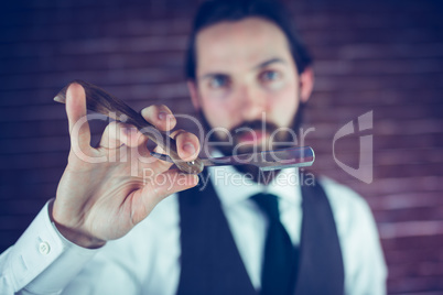 Portrait of smart hipster holding razor