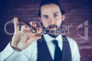 Portrait of smart hipster holding razor