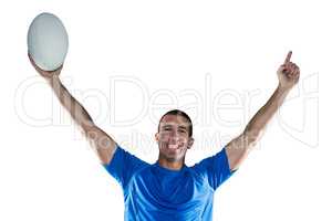 Portrait of rugby player in blue jersey holding ball with arms r