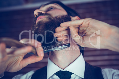 Hipster shaving beard
