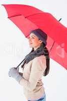 Smiling brunette holding red umbrella