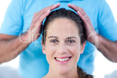 Portrait of smiling woman getting reiki treatment