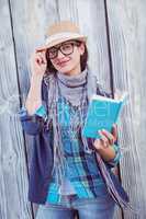 Happy hipster reading a book