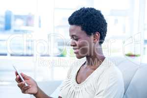 Happy pregnant woman holding mobile phone